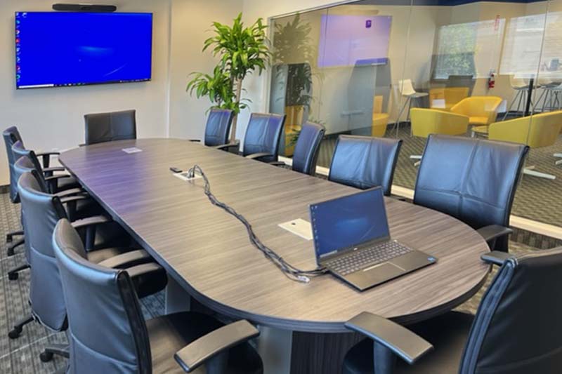 Conference Room with Screen & Laptop