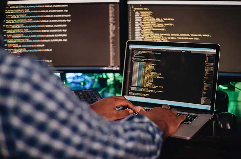 man sitting at a computer develop