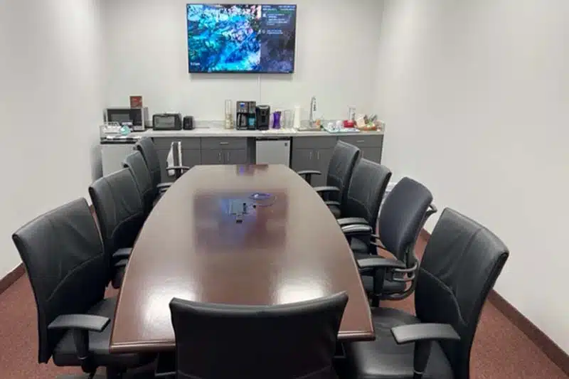 Conference Room with Screen & Laptop